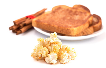 A Pile of Cinnamon Toast Flavored Popcorn on a White Background