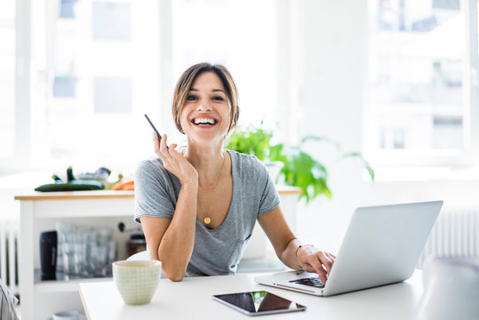 Happy Woman Sitting At Desk, Working From Home, Using Laptop