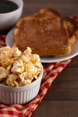 Bowl of Cinnamon Toast Flavored Popcorn on a Wooden Table