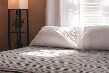 Fototapeta na wymiar Bedroom with black and white neutral decor in morning light