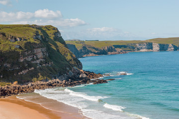 Mediterranean seacoast, Cantabria, Spain. Rocks, seaside, white foam and teal sea ocean water