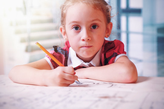 Humorous portrait of cule little child girl industrial engineer working in bureau of design and construction