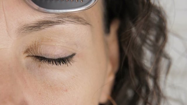 Perforated glasses. Woman's eyes with obscura glasses.