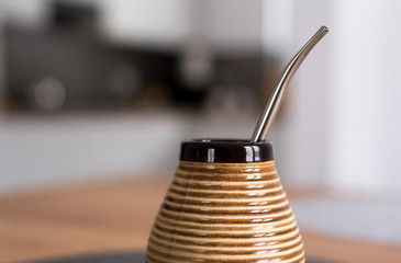 Traditional South American Yerba Mate tea in matero cup with bombilla metal straw servin...