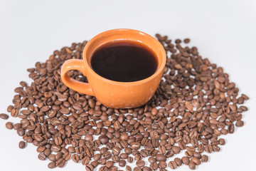 coffee beans and a cup of coffee on a white background