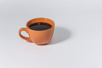 orange cup of coffee on a white background
