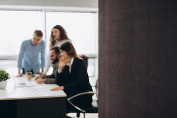 Young coworkers. Young modern colleagues in smart casual wear working while spending time in the office