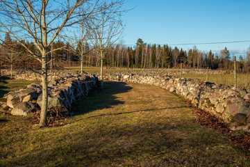Fototapeta na wymiar Old stone wall at pasture