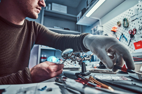 Electronic Technician Working In The Modern Repair Shop