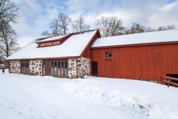 Winter scenery with red wooden house in Sweden
