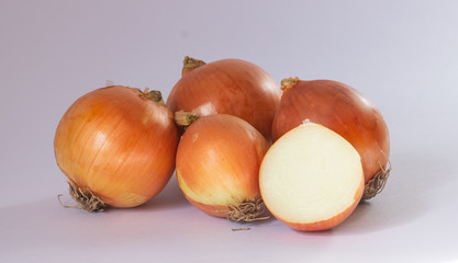 Many onions and a half on white background
