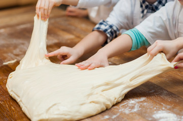 Small children take the dough. Hands close up
