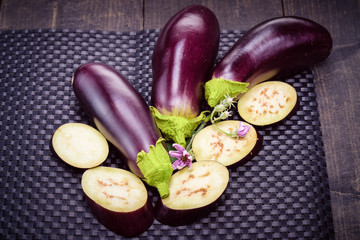 Dietary healthy food. Low-calorie product of healthy diet. Eggplant on the table. Still life of eggplants. Fresh sliced eggplant. Eggplant close up.