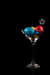 Easter Eggs and flower in Martini Glass on black background, Modern Design Easter Concept