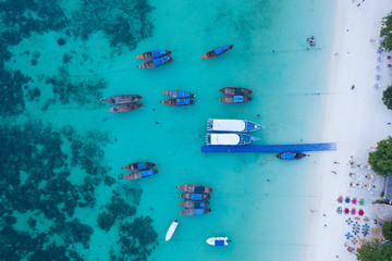 Longtail boats from the air, paradise island , crystal clear water, amazing scenery, on fyre. 