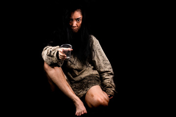 Young and dirty beggar asking for some money, Portrait of young beautiful homeless concept on black background