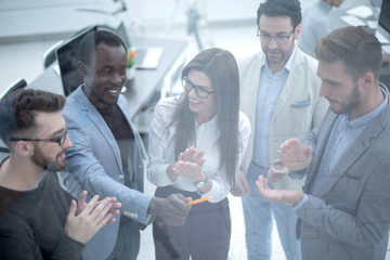 Group of business people clapping hands.