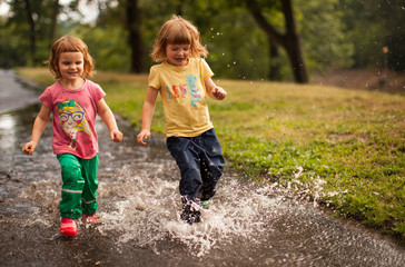Cute Kids Jumping into Water Puddle
