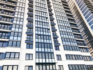 Texture of blue mirrored windows and balconies of a high modern monolithic-frame building, house, new buildings, skyscraper. The background. Texture
