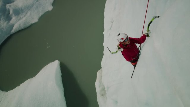 High angle view of ice climber using hooks ascending glacier / Palmer, Alaska, United States
