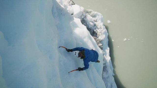 High angle view of ice climber using hooks ascending glacier / Palmer, Alaska, United States
