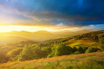 Fototapeta na wymiar Last rays of golden sunlight over the hills in Romania