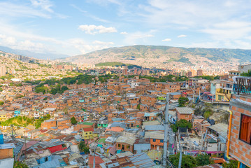 aerial view of Comuna or slum in Medellin Colombia. Comuna 13 is known for escalators between streets and Colourful buildings. Dangerous and poor Favela