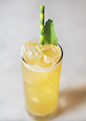 Bright Yellow Cocktail with Bamboo straw and Mint