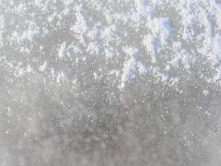Ice and snow texture, winter background: Frosty pattern on ice covered with crust snow