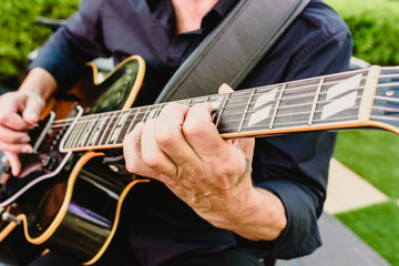 Guitarist playing his guitar outdoors