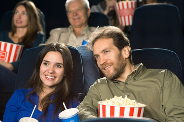 Happy mature couple enjoying movies together at the cinema
