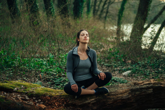 Young beautiful woman exercise in the forest