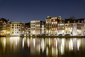 Fototapeta na wymiar Canals at night in Amsterdam (Netherlands). March 2015. Landscape format.