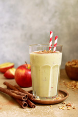 Homemade banana apple smoothie or lassi with cinnamon and oats.