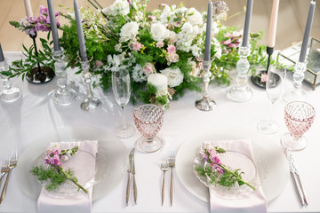 Floral decoration for wedding ceremony romance dining. Wedding banquet , festive decor. Bouquet from spring and summer flowers. Table layout. Restaurant interior. Concept of service and catering.