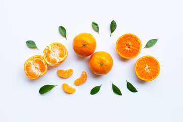 Orange fruits and green leaves on a white background.