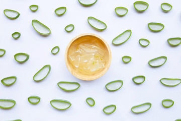 Aloe vera slices with aloe vera gel in wooden bowl on white