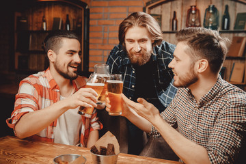 Meeting friends of men with draft beer bar in pub