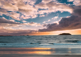 Island Craigleith at sunset before the storm. Dramatic sky has form of heart. North Berwick. East Lothian. Scotland. UK. long exposure photo. Soft light