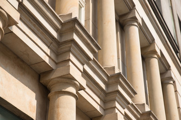 Stone pillars of classical European style close up. Play shadow and light, rhythm, meter