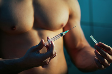 Close up of sportsman using steroids for increasing muscular growth.
