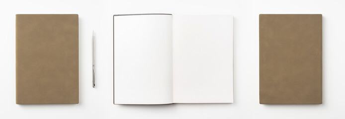 brown notebook and pen on white background