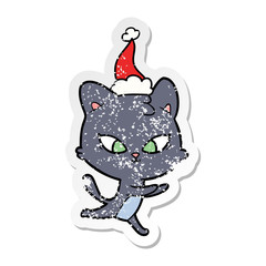 cute distressed sticker cartoon of a cat wearing santa hat