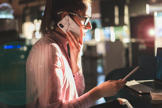 Woman working long hours, sitting in a coffee shop