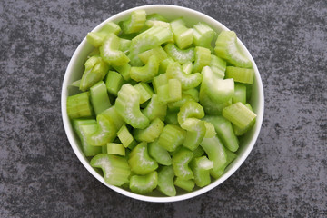 Chopped celery stalks in a bowl. Product for diet and proper nutrition.