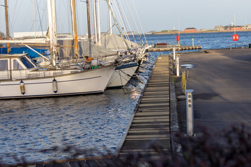 sailboats parked on harbor in a row