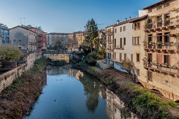 VICENZA, ITALY - DECEMBER 29, 2018: View from Ponte San Michele, ancient stone bridge in the historic city center - Vicenza, Italy 