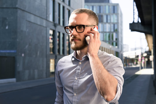 Businessman on cell phone in the city