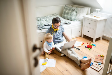 Father with his little son working from home