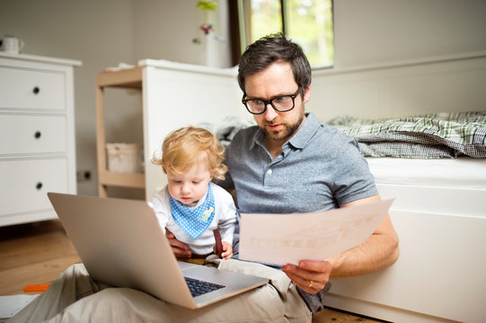 Father with his little son working from home